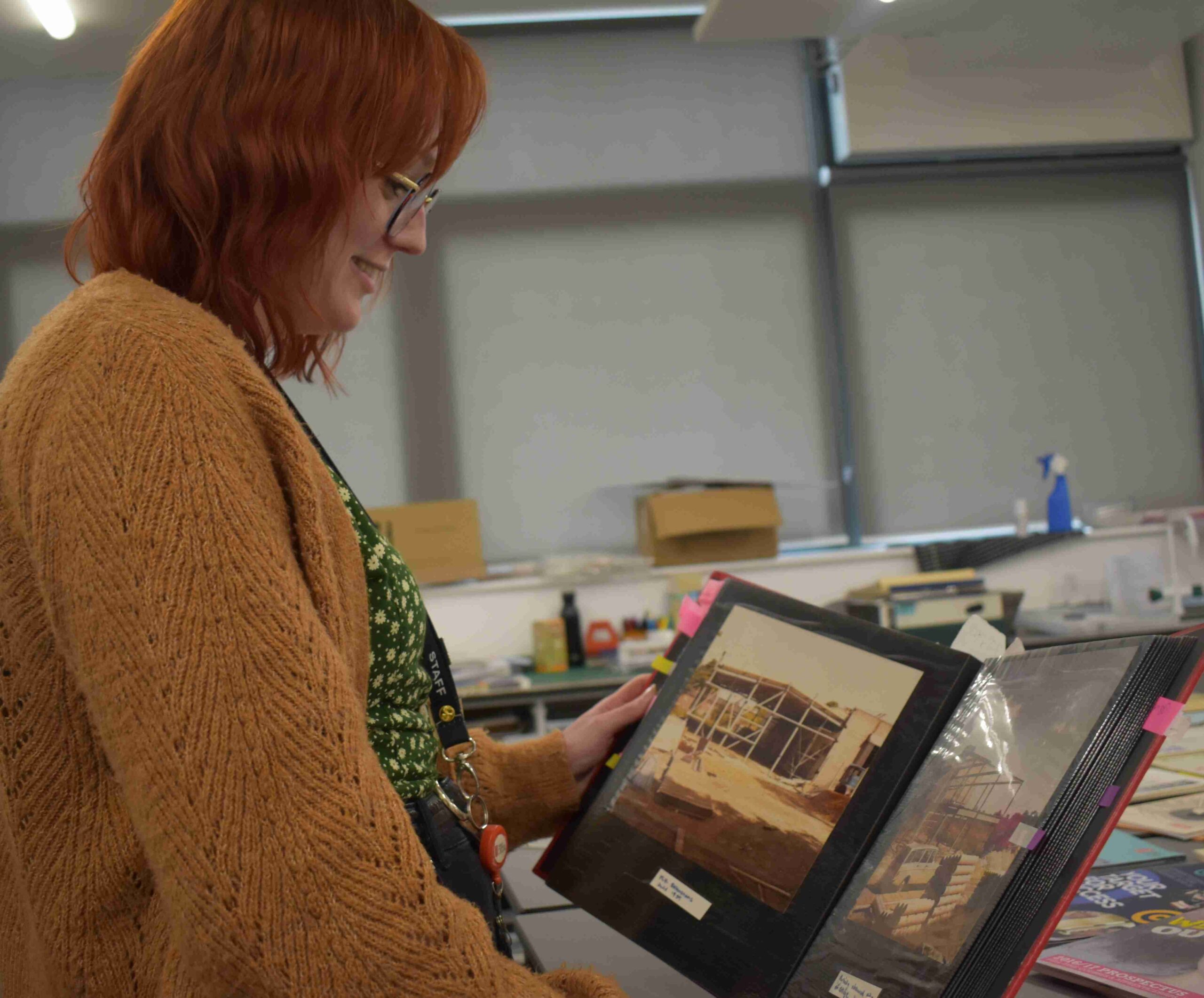 Siobhan Falconer looking at pictures of the original WSC building - many items that have been found in the archives.