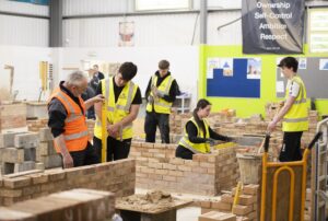 Construction students and tutors in the bricklaying workshop at West Suffolk College
