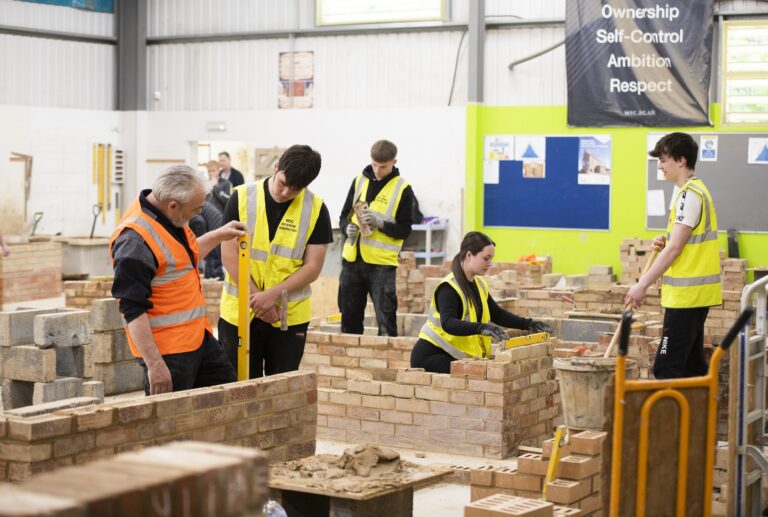 Construction students and tutors in the bricklaying workshop at West Suffolk College