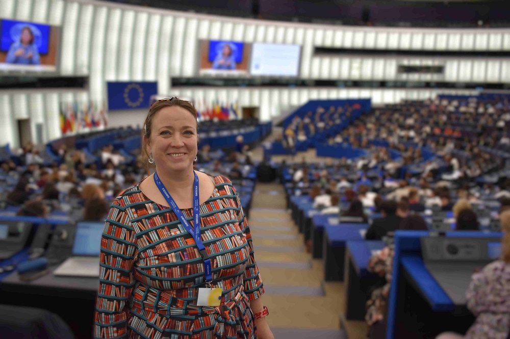 Jen inside the EU parliament proud of what she and her students have achieved