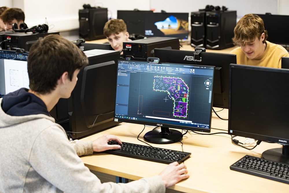 Male students looking at floorplans on a monitor