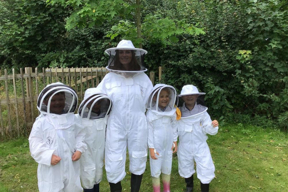 Pupils doing beekeeping at Exning Primary School near to Newmarket, Suffolk