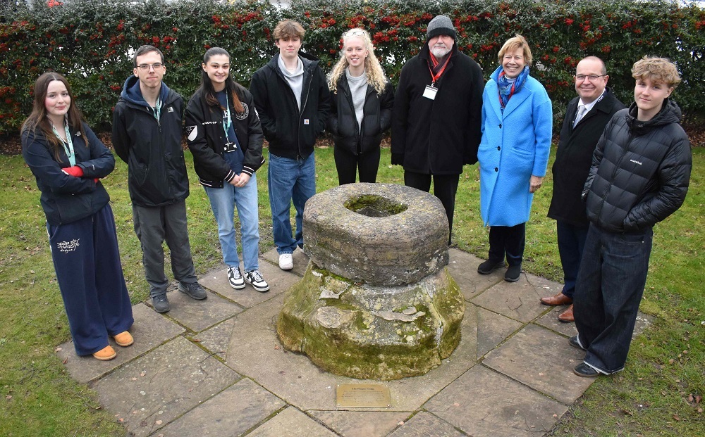 Local residents Martyn Taylor and Melanie Lesser with staff and students from Easter Education Group at the official unveiling of a plague stone plaque in Bury St Edmunds.