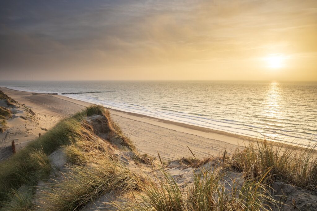 sunset over sea beach from sand dunes