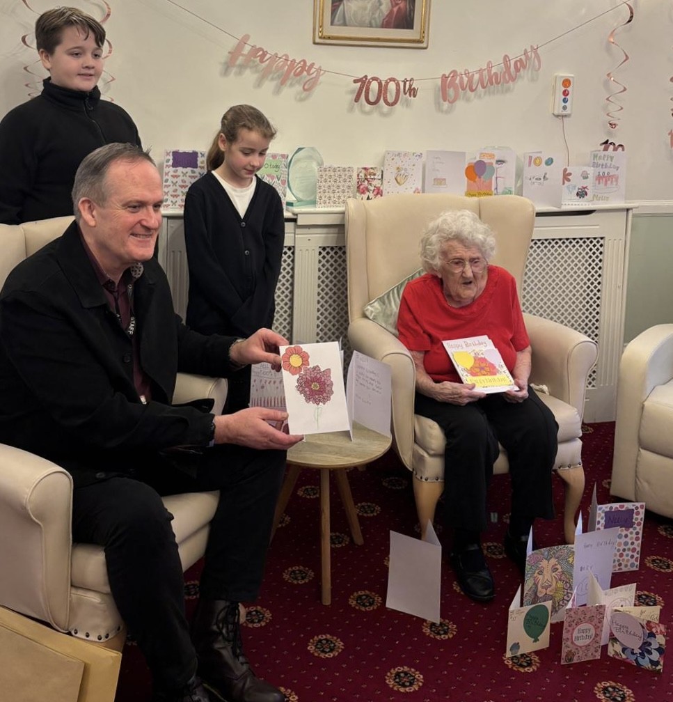 Patrick Hamilton from Sunrise Academy with students who made cards for Nelly - a Lound Hall resident - who is turning 100 next week - photo by Lound Hall