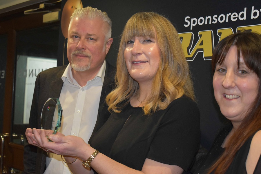 An apprentice with their award