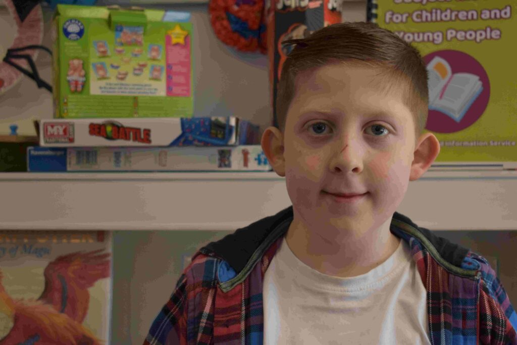 Remi from Duke of Lancaster finding out about books at the library in Fakenham
