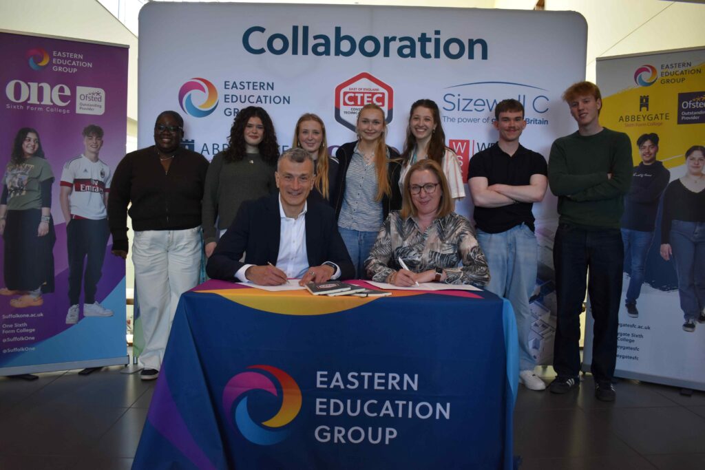 Regional education group and Sizewell C agree new partnership 6 1a Dr Nikos Savvas OBE DL with Sarah Hancock from Sizewell C as the next generation look on over the MOU signing