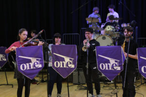 Students playing musical instruments including violins