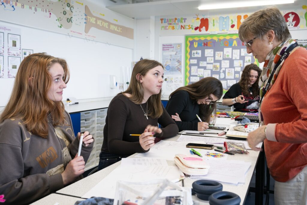 Explore University 4 students with a teacher