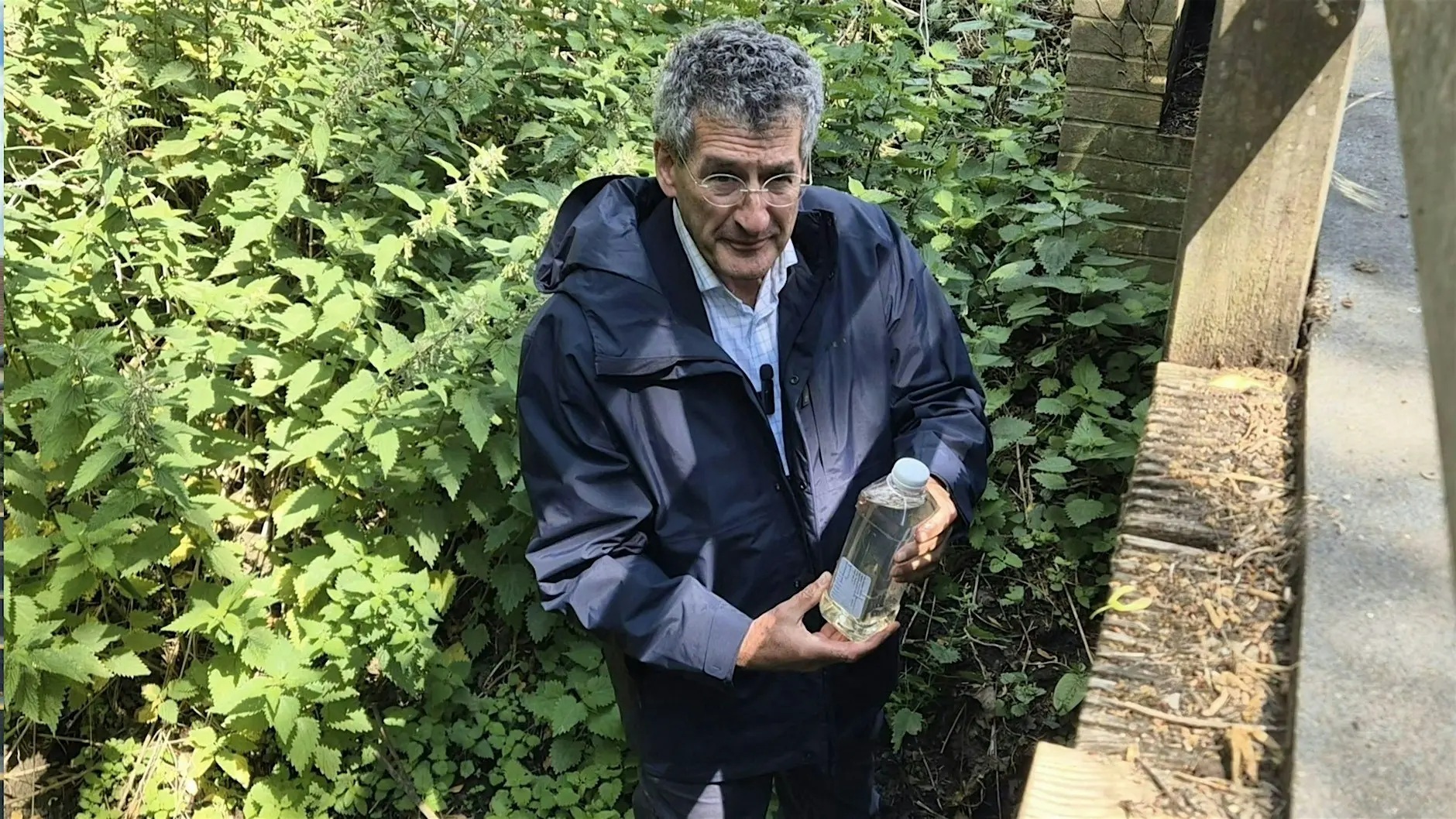 Peter Prinsley holding a water sample