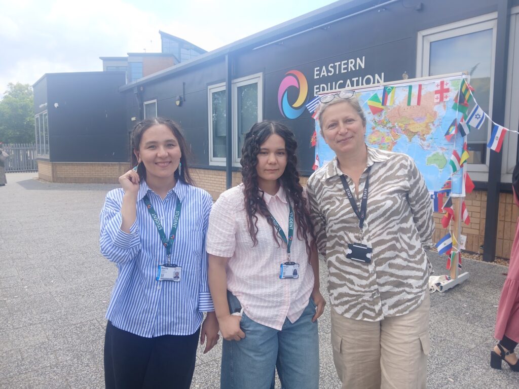 Three people with the map of the world in the background