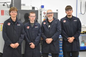 students in the Gene Haas Foundation Centre in Bury St Edmunds with their tutor Derek - reflecting on the importance of National Manufacturing Day