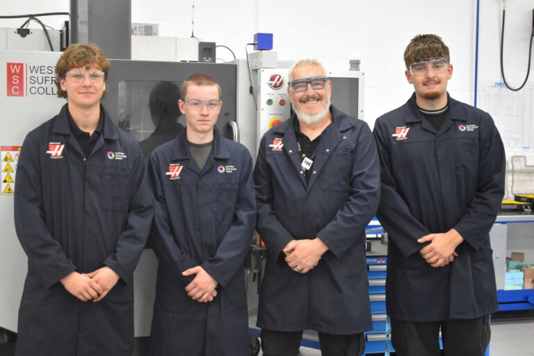students in the Gene Haas Foundation Centre in Bury St Edmunds with their tutor Derek - reflecting on the importance of National Manufacturing Day