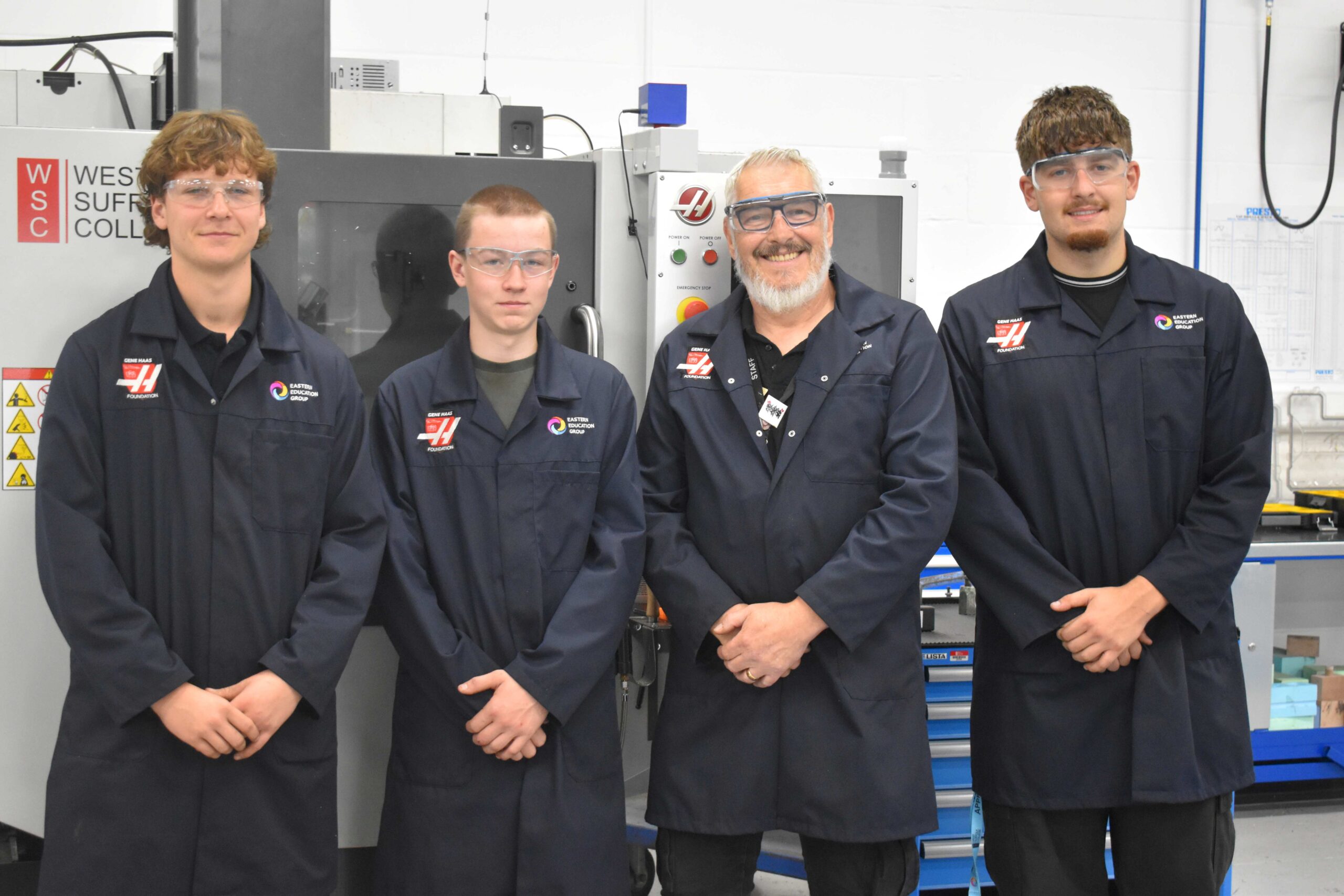students in the Gene Haas Foundation Centre in Bury St Edmunds with their tutor Derek - reflecting on the importance of National Manufacturing Day